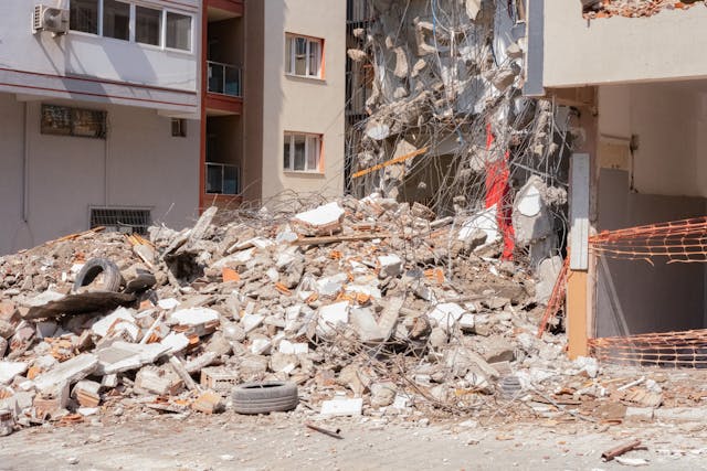 Severely damaged building with structural collapse and debris from property loss event