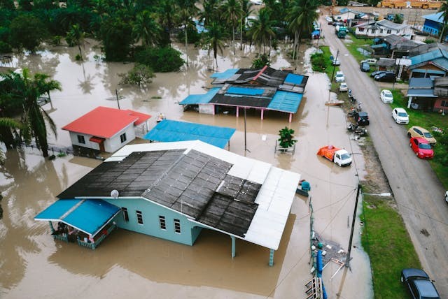 Aerial view of flooded residential neighborhood showing widespread property damage