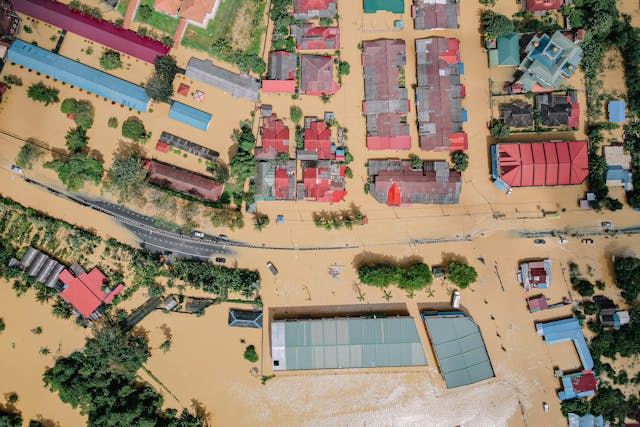 Aerial view of widespread flooding across residential and commercial buildings
