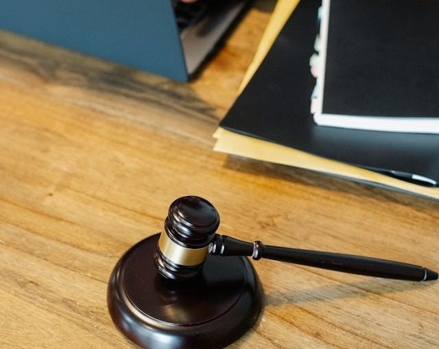 Gavel on desk beside legal documents representing insurance dispute resolution