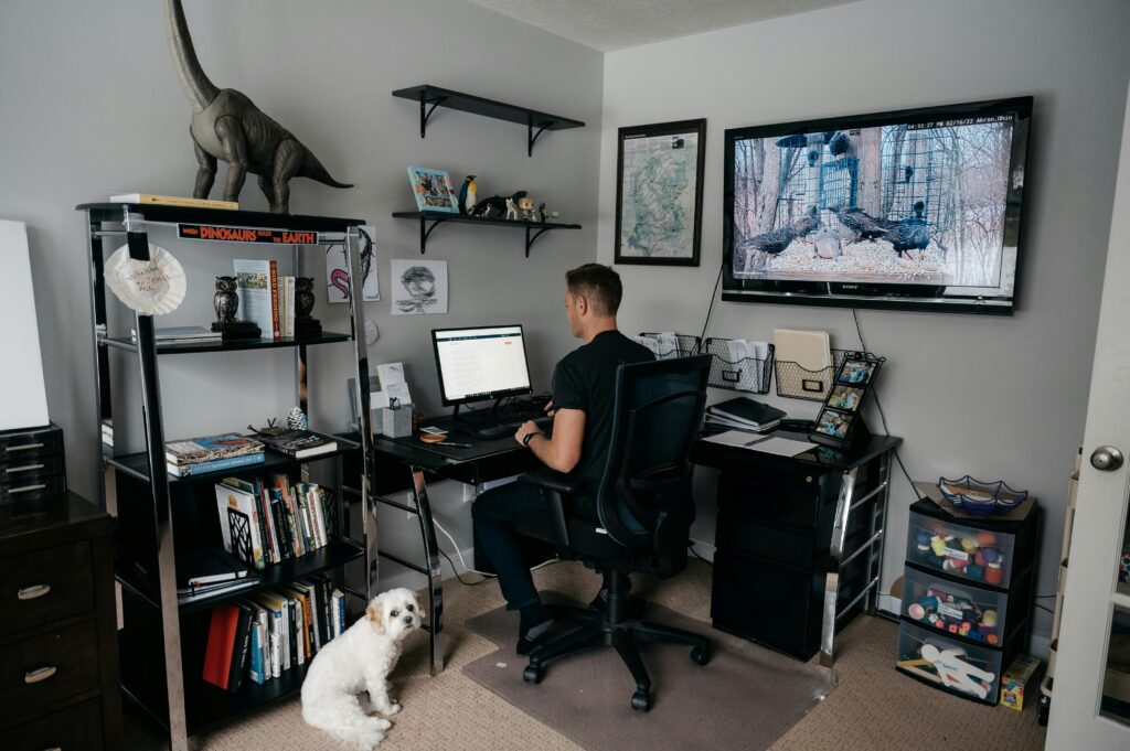 Man working from home office, highlighting potential insurance exclusions for home-based business activities.