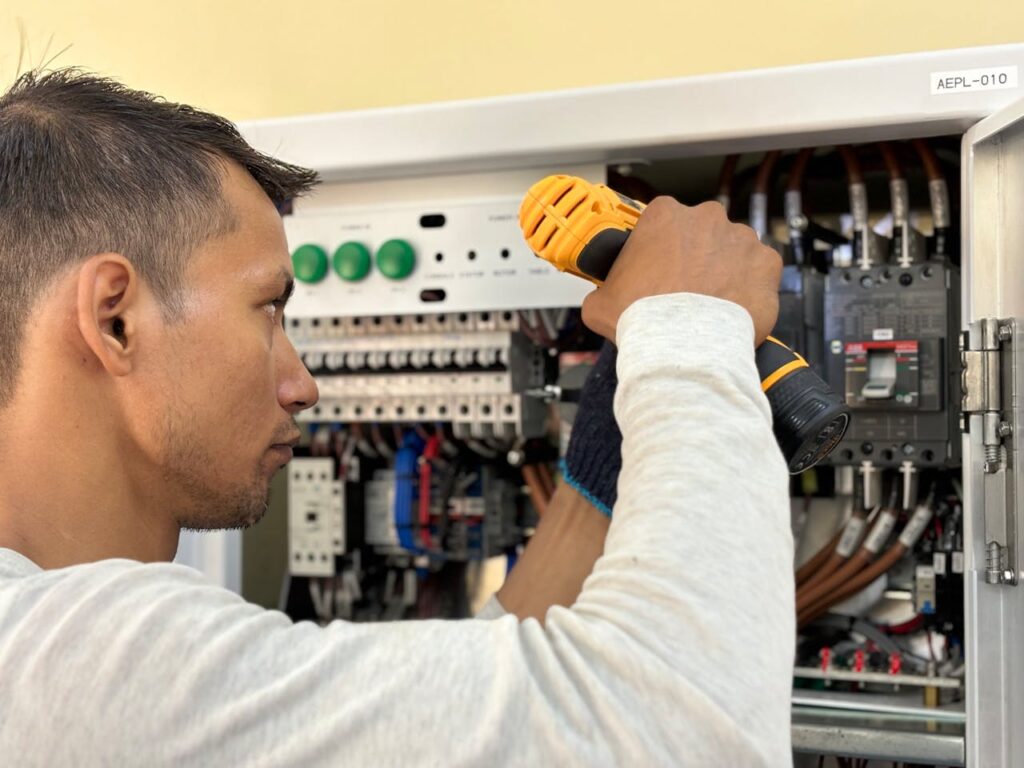 certified electrician upgrading electrical panel to meet building code standards
