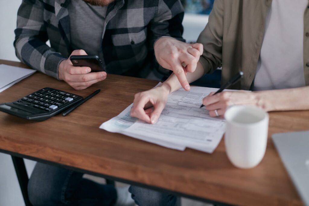 Policyholder reviewing insurance claim paperwork with personal details blurred