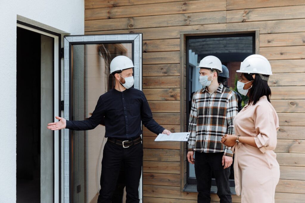 construction team reviewing damage and rebuilding plans on-site after a disaster