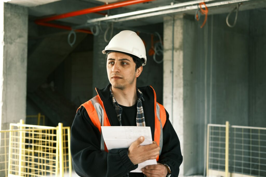Building inspector ensuring ordinance and law compliance during rebuild