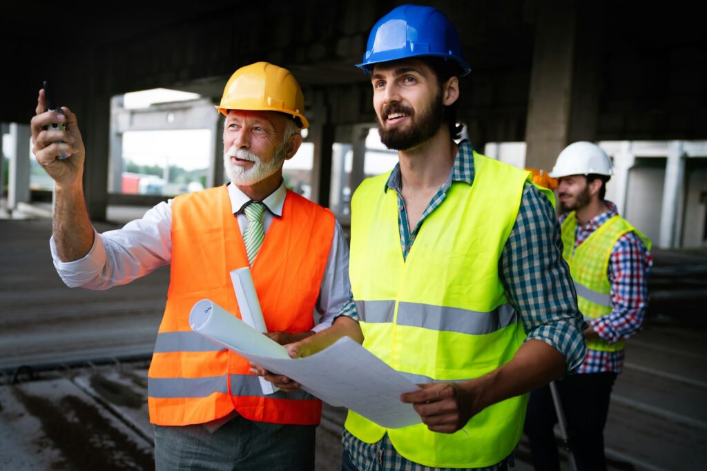 Construction team ensuring code compliance during property rebuild after disaster