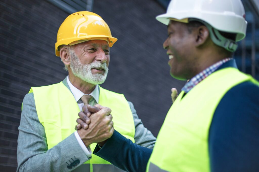 Property owner shaking hands with public adjuster after successful claim settlement