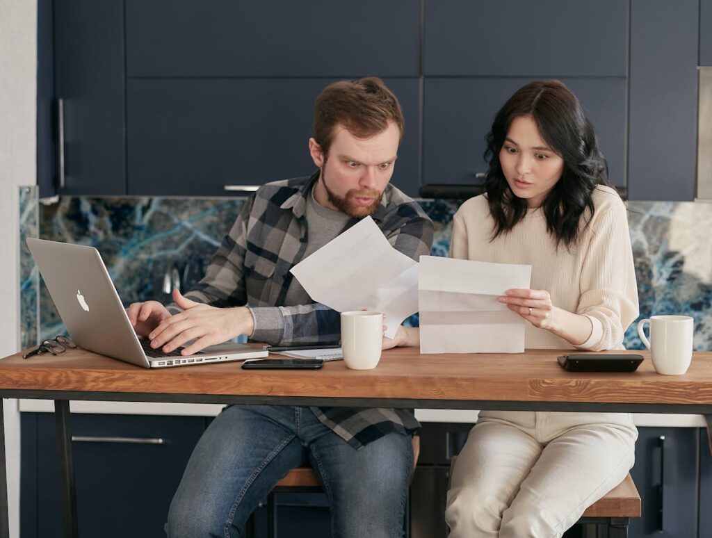 Policyholder reviewing insurance paperwork due to insurance claim delay