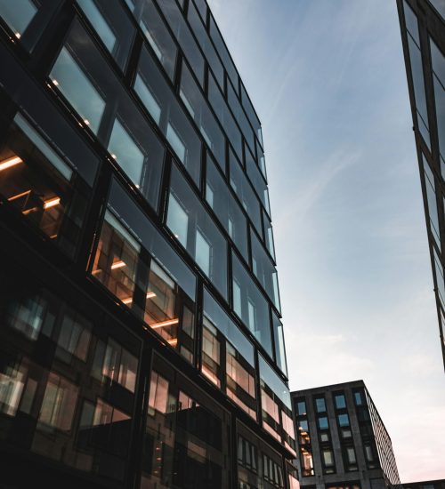 Modern glass commercial office buildings in urban setting at sunset