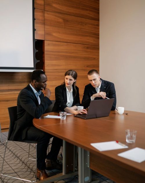 Insurance professionals discussing a complex claim strategy during a team meeting