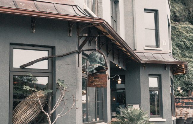 Exterior of a commercial building with signage and storefront windows